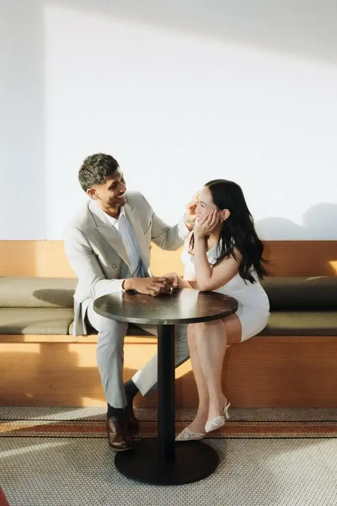 Neel and Grace laughing together at a café table