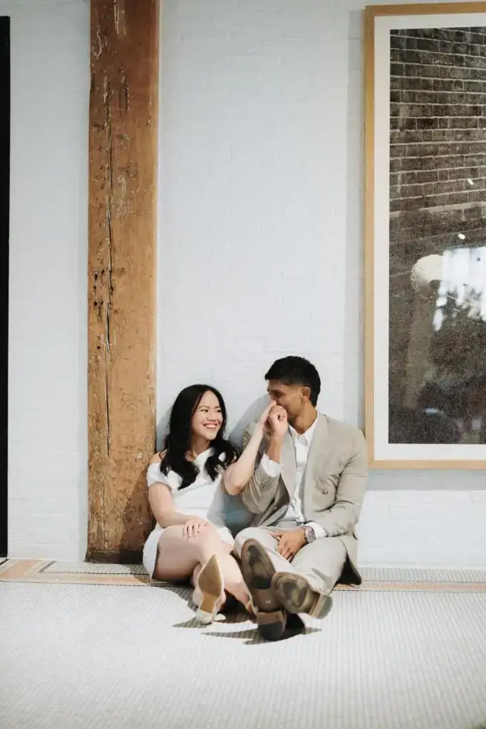 Neel kissing Grace’s hand as they sit together