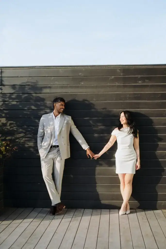 Neel and Grace holding hands on the rooftop