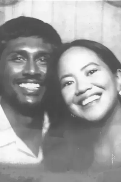 Neel and Grace smiling together in a photobooth