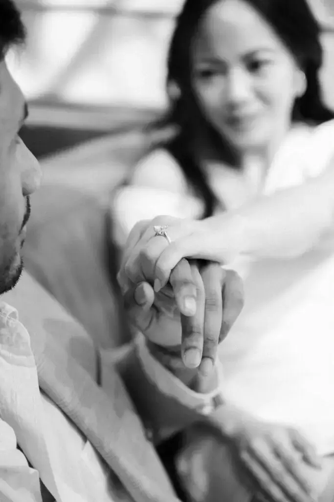 Neel kissing Grace’s hand, with her engagement ring in focus