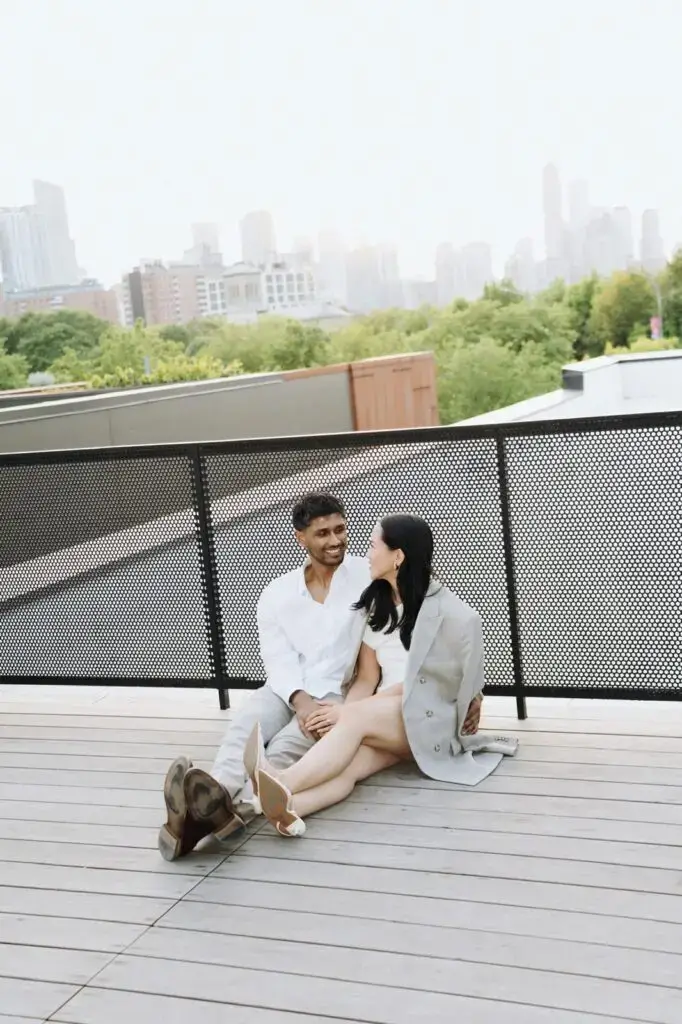 Neel and Grace seated on a rooftop overlooking Toronto