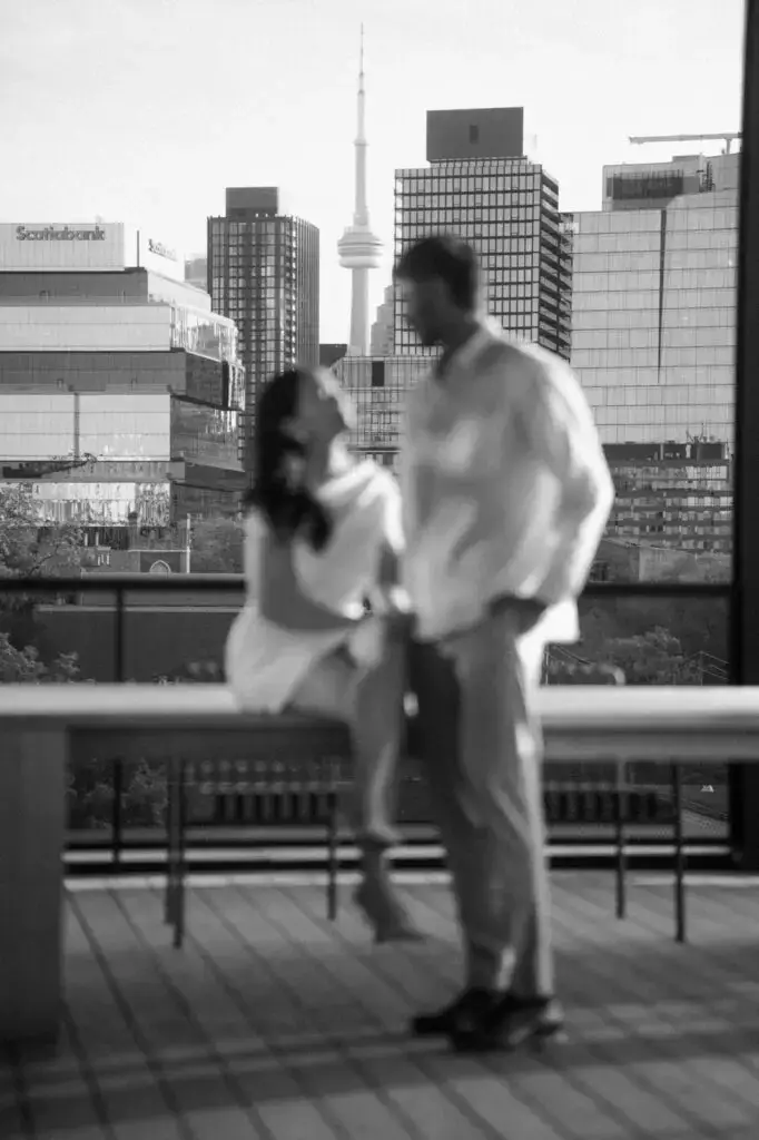 Neel and Grace in soft focus with the Toronto skyline behind them